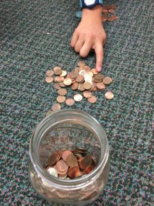 one student plays the penny game