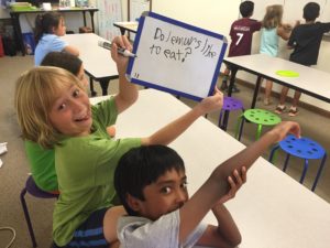 students writing out the sentence scramblers