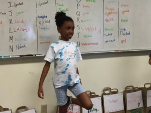 a student standing in front of a group speaking a fact or opinion