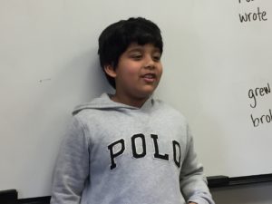 a boy speaking three nouns