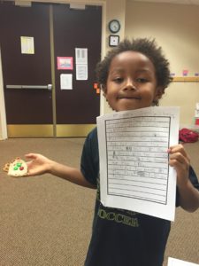 a boy proud of his writing and reindeer sandwich