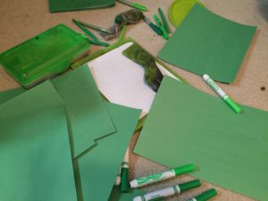 Green art materials on the floor