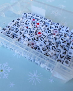white beads with black letters on them for the candy cane ornament