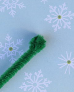 one green pipe cleaner balled up at the end