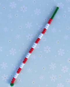 one green pipe cleaner with a pattern of red and white beads