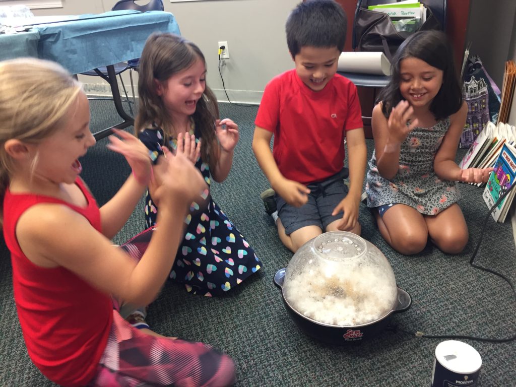 Children watch popcorn pop