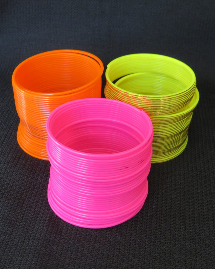 orange slinky, yellow slinky, pink slinky