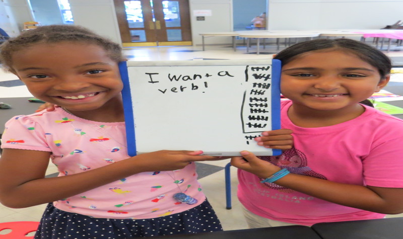 students writing an exclamation on a whiteboard