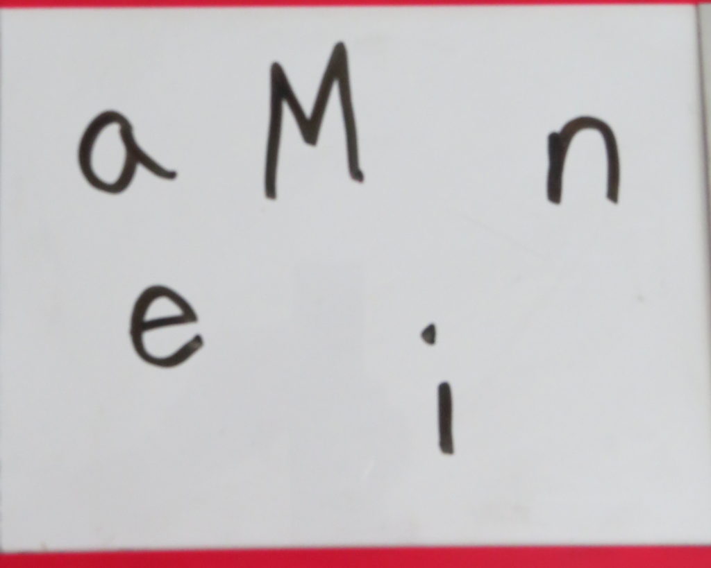 Students write scrambled letters in order to make a word