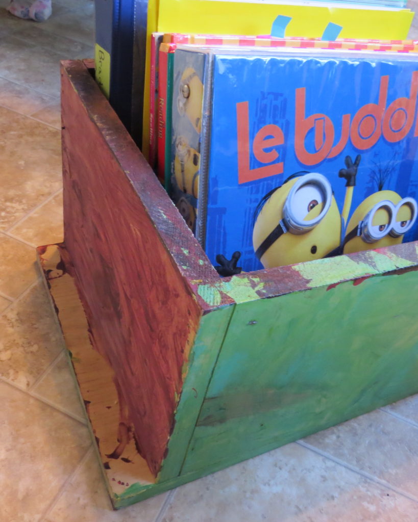 a painted wooden box full of books