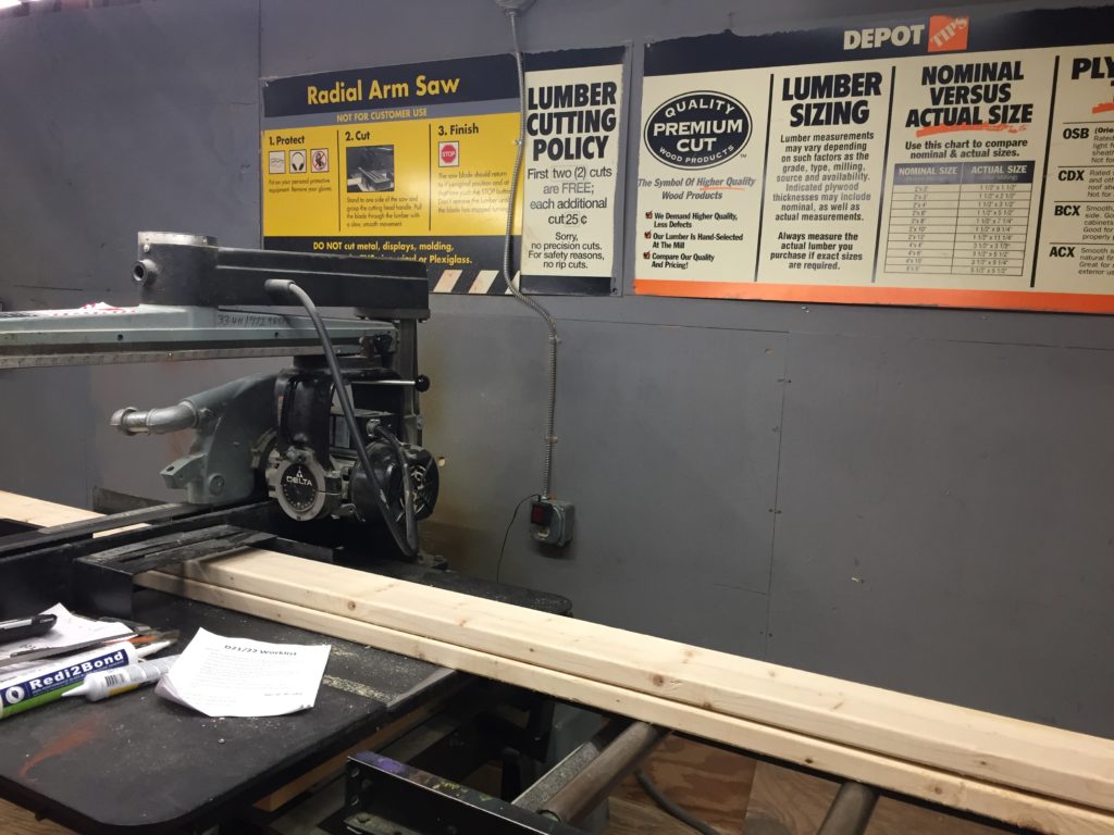 The saw at Home Depot that cuts the wood for the shelf building project for kids