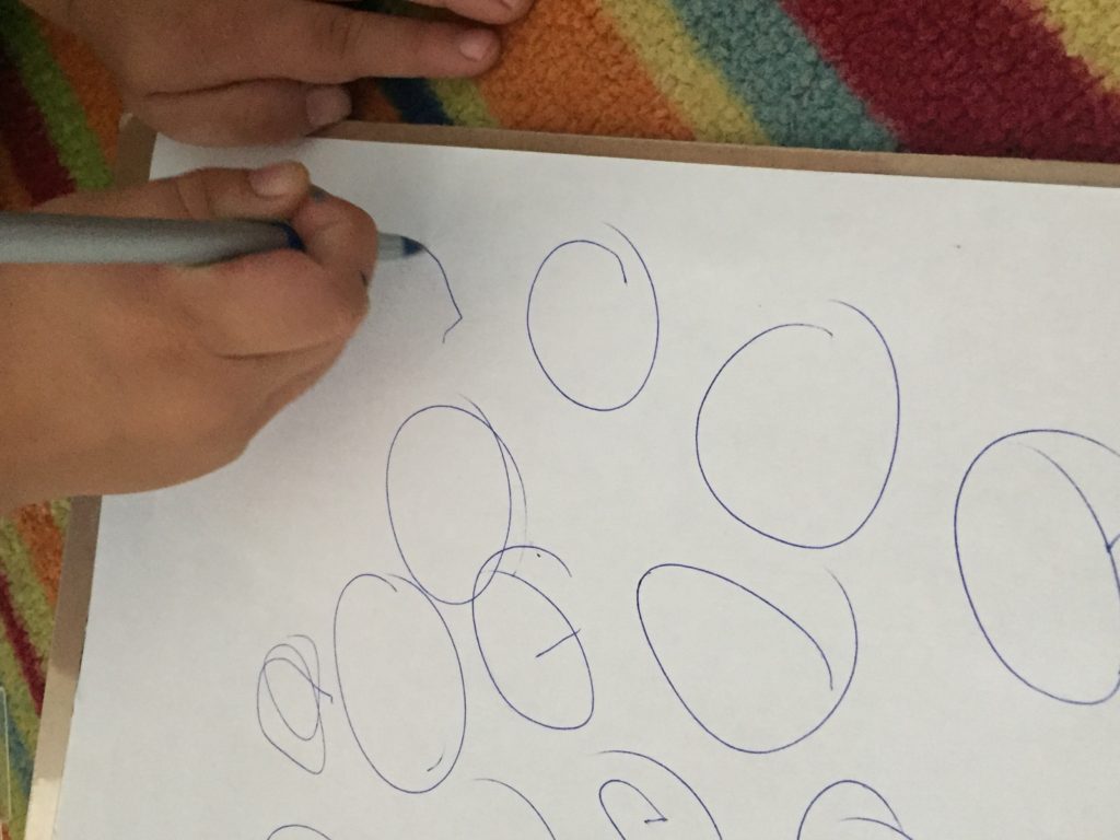 Child writing circles 