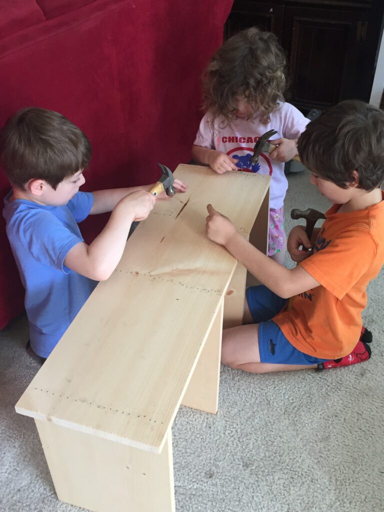 three kids build a 4 tier shelf
