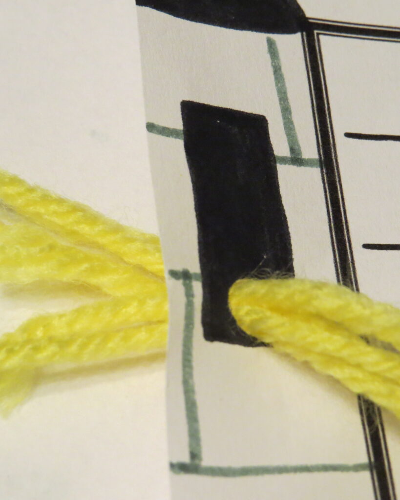 Rapunzel-thread the yellow yarn through the hole